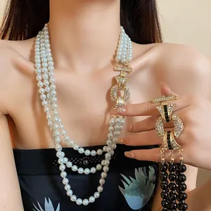 Primo piano di una lussuosa collana di perle a tre fili con ciondolo di strass in stile francese
