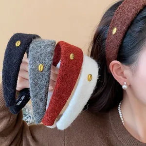 Detailed view of colorful flocked wide headbands with gold KOREA decorative metal accents