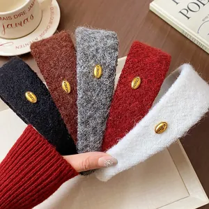 Detail view showing fuzzy texture and gold Korea metal tag on wide headbands.