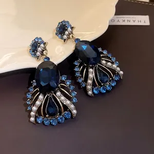 Elegant vintage dark blue crystal and pearl waterdrop earrings with a gold-tone setting
