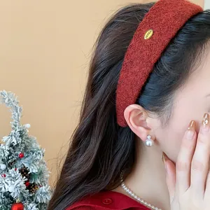 Close-up detail of a wide red flocked headband worn by a model for a high-top hair look.