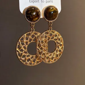 Retro vintage style hollow round dangle earrings with tiger eye stone and gold finish