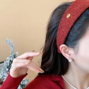 Close-up of a stylish rust-red flocked wide headband worn by an elegant female model