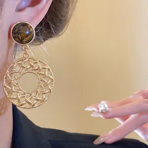 Retro S925 silver needle tiger eye stone earrings with elegant hollow circular pendants