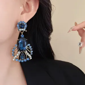 Elegant vintage drop earrings featuring deep blue crystals and pearls for a luxurious look