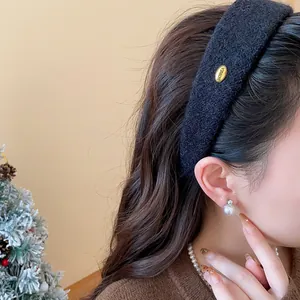 Close-up of a stylish black flocked wide headband worn by a model for extra volume.