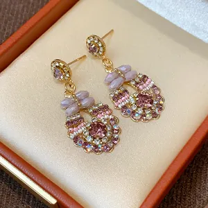 Luxury pink crystal and bead drop earrings with bow detail presented in an orange gift box