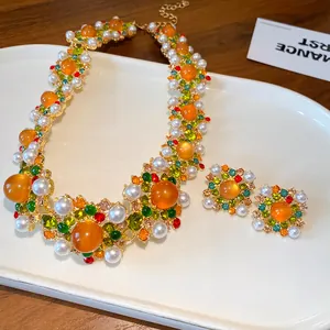 Detail view of a luxury vintage baroque necklace and square earring jewelry set.