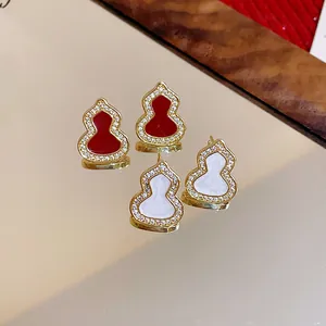 Close-up of elegant gourd-shaped earrings with zircon and enamel detailing