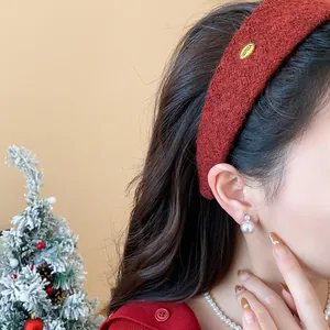 Detail of a stylish red flocked wide headband worn by a model in a festive setting