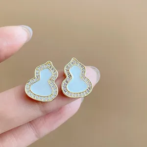 Detailed macro shot of elegant gourd-shaped stud earrings with zircons and oil-dripped enamel