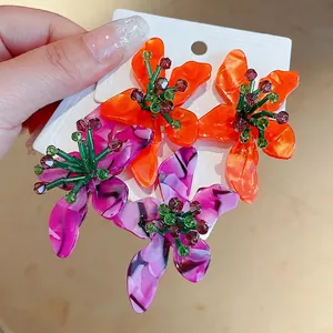Vibrant floral acetate stud earrings with green crystal beads and silver needles.