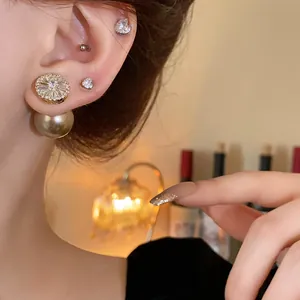 Elegant gold-plated pearl stud earrings featuring shimmering cubic zirconia details