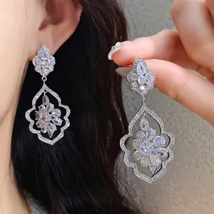 Luxury silver-tone drip earrings featuring sparkling CZ stones in a floral leaf design