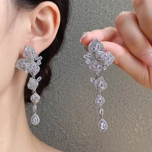 Elegant silver-toned leaf-shaped tassel earrings with sparkling cubic zirconia stones.
