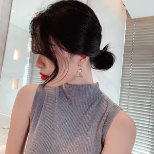 Elegant vintage ethnic style triangle drop earrings for women worn by an Asian model
