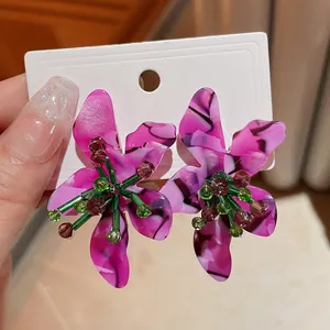 Detail view of purple acetate flower earrings with crystal beads on silver needle