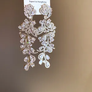 Close-up of elegant leaf-shaped chandelier earrings with sparkling marquise-cut zircon stones