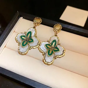 Vintage court style floral drop earrings with white petals and green enamel center