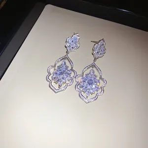 Detailed close-up of sparkling zircon drop earrings with intricate craftsmanship