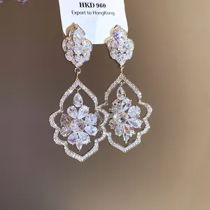 Close-up of ornate zircon flower drop earrings with baroque style frame