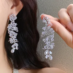 Detail of sparkling zircon leaf tassel earrings showing wearing effect and macro view
