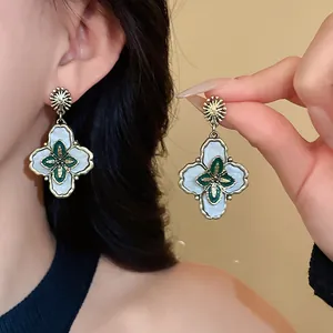 Vintage palace style flower drop earrings with green enamel detail and silver needles