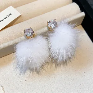 Elegant zirconia and white fur ball stud earrings for autumn and winter fashion styles.