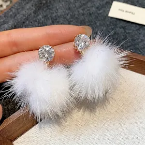 Elegant white pom-pom stud earrings with sparkling round cubic zirconia stones for winter