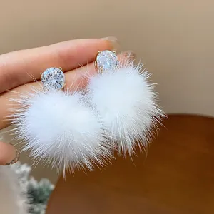 Elegant cubic zirconia stud earrings with fluffy white fur pom-poms for winter style