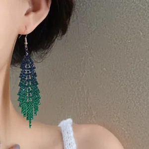 Detail view of elegant blue-green gradient rhinestone long tassel earrings for women