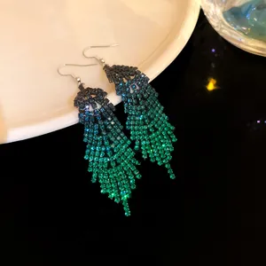 Sparkling long tassel earrings with gradient teal rhinestones in feather shape design