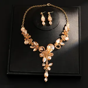 Elegant gold-tone jewelry set with champagne crystal teardrop necklace and earrings