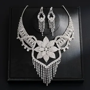 Detailed view of elegant silver rhinestone necklace and tassel earring jewelry set