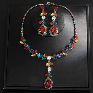 Detailed view of vintage multi-colored rhinestone necklace and teardrop earring jewelry set