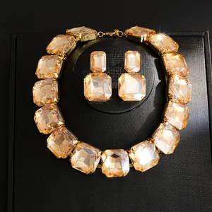 Detailed view of a luxury vintage necklace and earrings set featuring champagne crystals