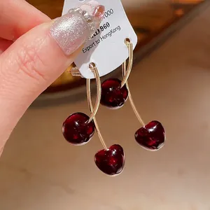 Elegant vintage cherry resin drop earrings with glossy red fruit and golden ear hooks