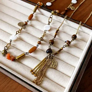 Vintage ethnic long necklace with ceramic beads and portrait coin tassel pendant detail