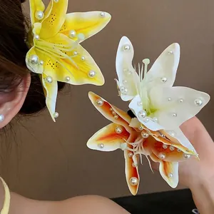 Elegant fabric lily flower hair clips with white pearl accents worn by an Asian model