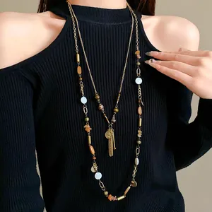 Vintage style double-layer long sweater necklace with ceramic beads and gold portrait charms