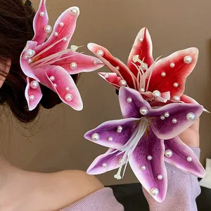 Detail view of colorful fabric lily hair clips featuring elegant pearl embellishments