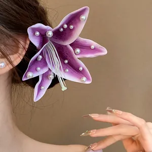 Detail view of elegant purple fabric lily hair clip decorated with delicate white pearls