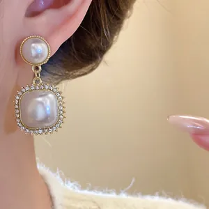 Close-up detail of French vintage geometric pearl earrings with shimmering rhinestones