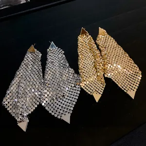 Detailed view of gold and silver triangle sequin mesh earrings on black display
