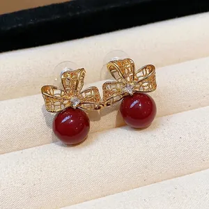 Elegant vintage 18k gold plated filigree bow earrings with red pearls and zircon stones