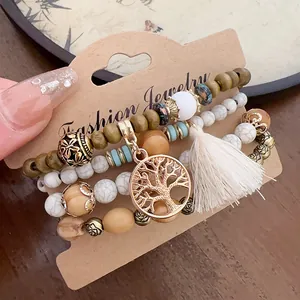 Close-up of Bohemian multi-layer beaded bracelet set with Tree of Life charm and tassel details