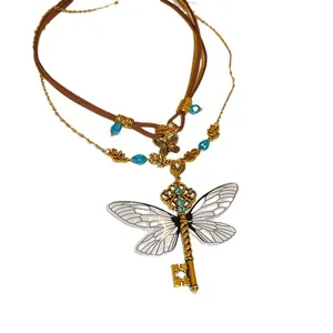 Vintage punk necklace featuring a dragonfly wing key pendant with blue rhinestones