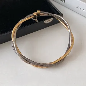 Elegant multi-layered twisted metal choker necklace with gold and silver metallic finish