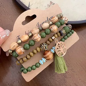 Bohemian multi-layer beaded bracelet set with green tassel and Tree of Life charm.