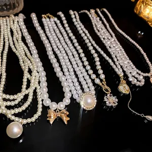 Elegant multi-style pearl necklace set with bow, flower and heart gold pendants